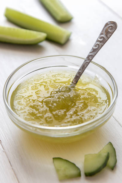 istock Cucumber jam in a transparent bowl with a spoon on a white background 1189173064