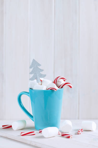 istock Delicious drink with marshmallows and Christmas candy can on table 1189174145