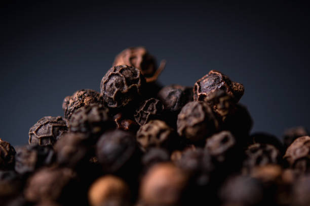 istock black pepper close-up on a blue background 1189175353