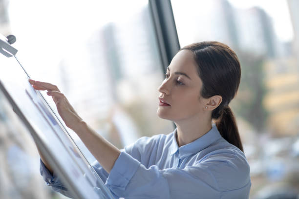 istock Businesswoman standing while working on new business plan 1189175535