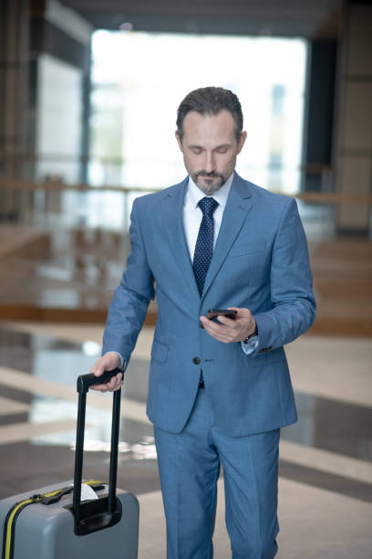 istock Bearded businessman texting his wife while having business trip 1189175571
