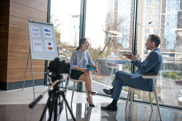istock Journalist enjoying communication with businessman while filming video 1189176088
