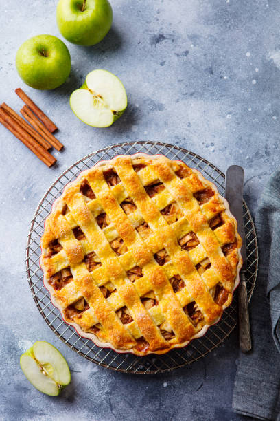 istock Apple pie with caramel on a cooling rack. Grey background. Copy space. Top view. 1189177367
