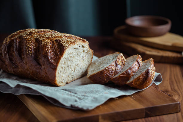 istock Whole grain loaf bread with chia seeds on a cutting board. Healthy eating concept. 1189178628
