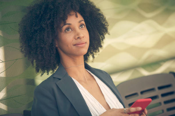 istock Woman with mobile phone at the bus station 1189179078