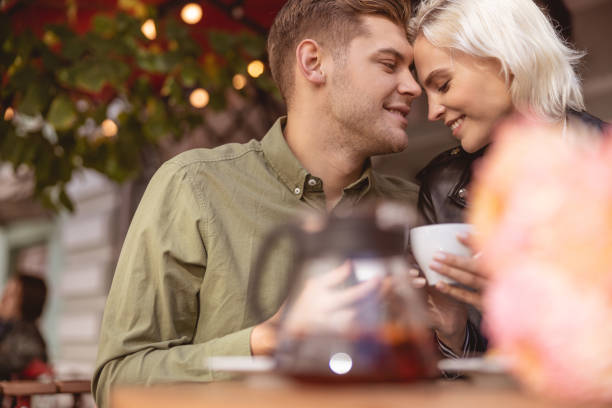 istock Loving couple is drinking hot drink coffee house 1189179153