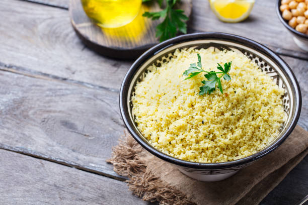 istock Couscous in bowl. Wooden background. Close up. Copy space. 1189179209