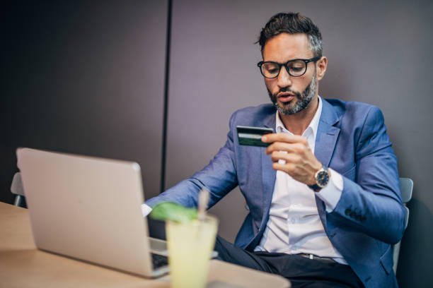 istock Man with credit card in cafe 1189180968