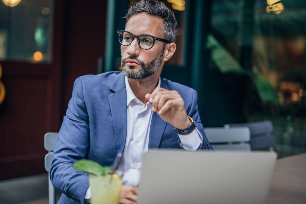 istock Young man sitting in coffee shop and using laptop 1189181583