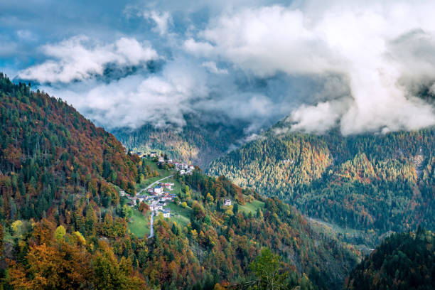 colourful aumtumn view across the cordevole valley with pecol and piaia villages in the background in belluno, italy - cordevole valley imagens e fotografias de stock