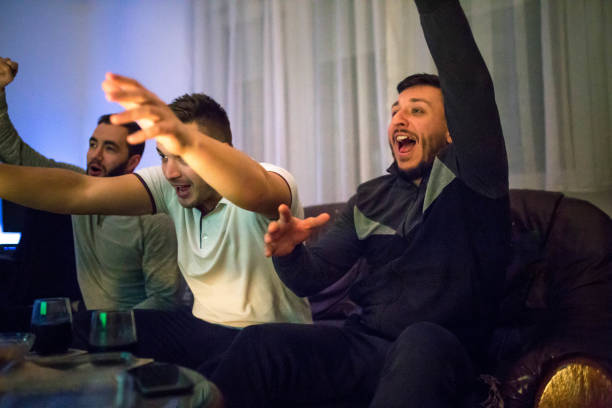 istock Male friends watching a soccer match 1189184809
