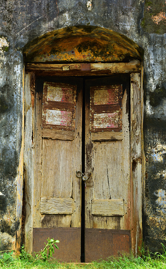 Burnt wooden door. A burnt wooden round door of old castle in West Bengal, India.