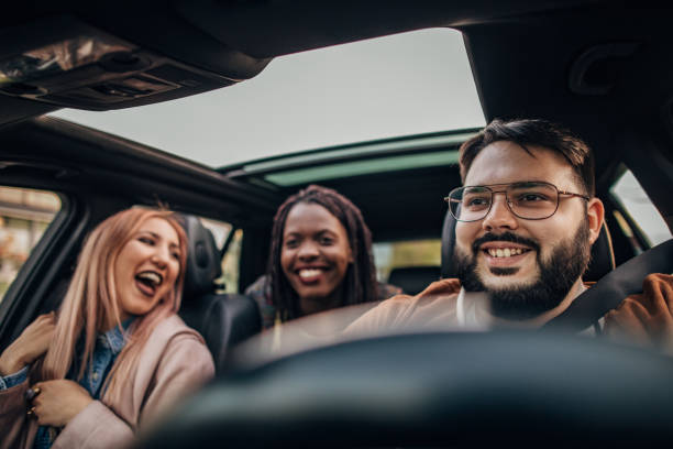 istock Cheerful friends traveling by a car 1189186571