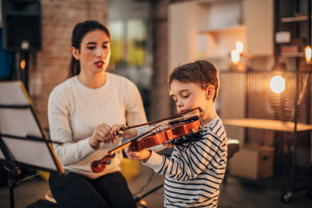 istock Little boy teaching to play violin 1189187742