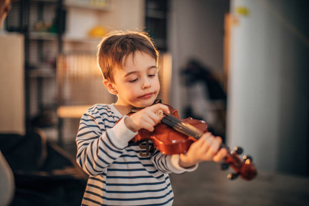 istock Little boy teaching to play violin 1189187868