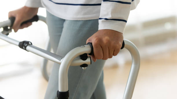 istock Disabled senior woman standing alone holding walking frame, close up 1189188602
