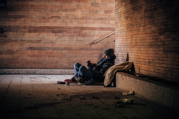 istock Homeless man playing guitar  in underpass tunnel 1189189564