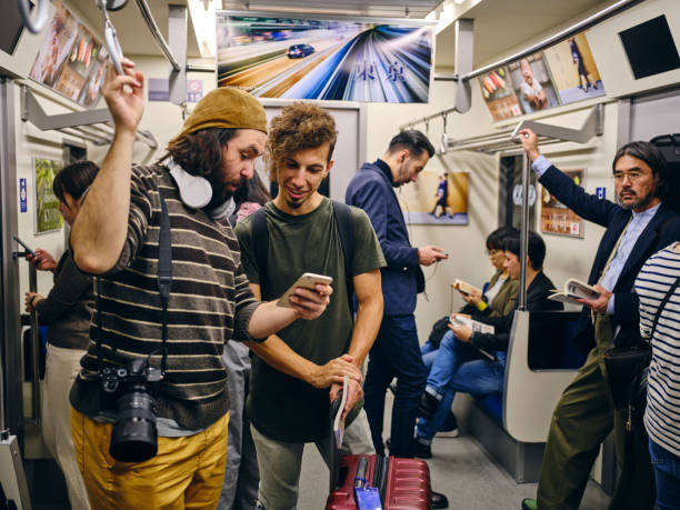 istock Tourists on a Crowded Japanese Subway Train 1189189587