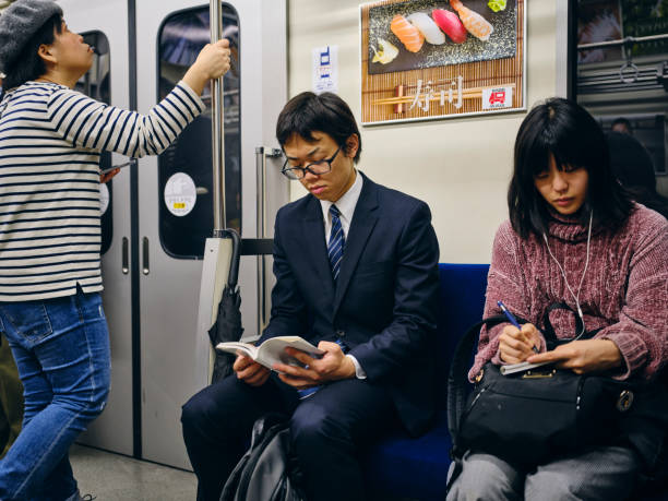 istock Young Woman on a Crowded Japanese Subway Train 1189190233