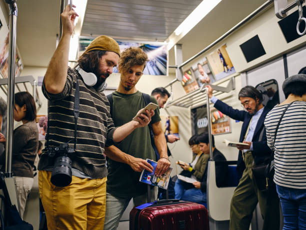 istock Tourists on a Crowded Japanese Subway Train 1189190283