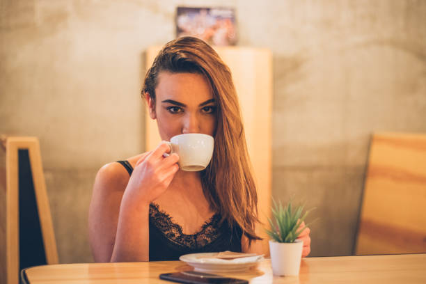 istock Beautiful young woman in cafe 1189192202