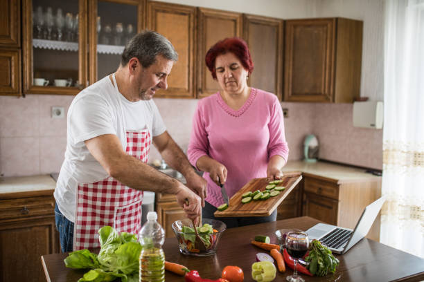 istock Senior couple making a meal together 1189192523