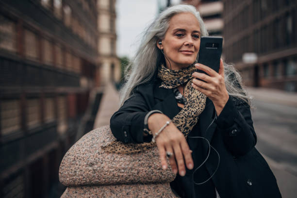 istock Beautiful senior woman using phone 1189194857