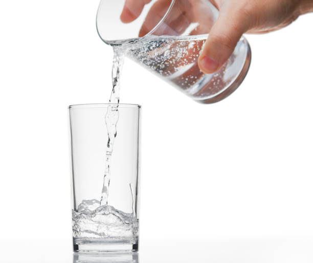 istock pouring sparkling water in a glass on white background, isolated object 1189198270