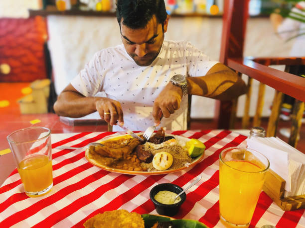 istock Man eating local colombian food 1189200043