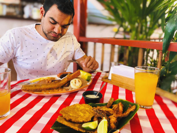 istock Man eating local colombian food 1189200170