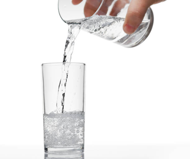 istock pouring sparkling water in a glass on white background, isolated object 1189200577