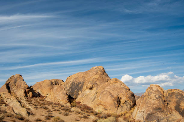 istock striped clouds in blue sky above desert rock formations 1189205052
