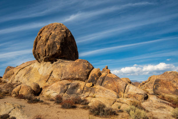 istock striped clouds in blue sky above desert rock formations 1189205110