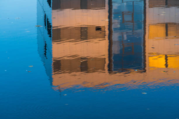 Reflection of modern building. Ripple on water.