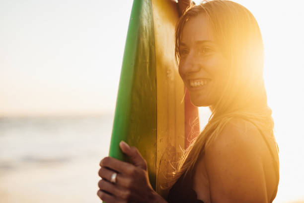 istock Woman with surfboard 1189207037