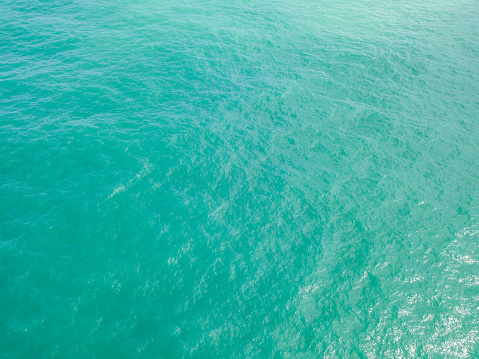 Aerial view of turquoise waves, water surface texture. Thailand