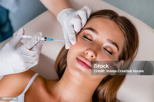 Young Woman Gets Beauty Facial Injections In Salon Stock Photo - Download Image Now - Botulinum Toxin Injection, Injecting, Human Face