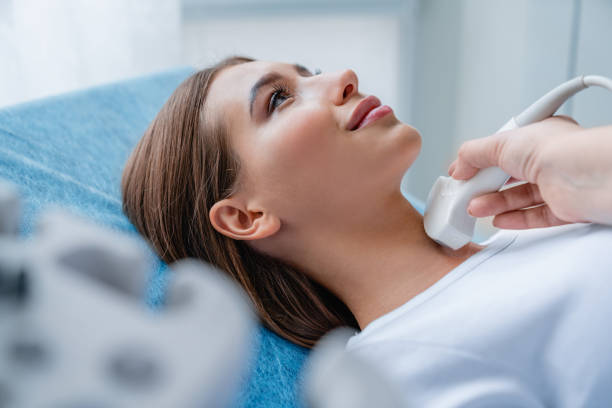 Close up shot of young woman getting her neck examined by doctor using ultrasound scanner at modern clinic Medicine, Hospital, Medical Clinic, Ultrasound, Doctor thyroid gland stock pictures, royalty-free photos & images