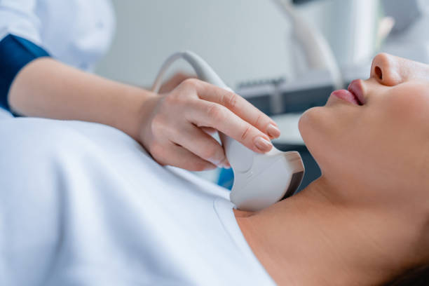 Close up of doctor conducting ultrasound examination of woman in clinic Medicine, Hospital, Medical Clinic, Ultrasound, Doctor thyroid gland stock pictures, royalty-free photos & images