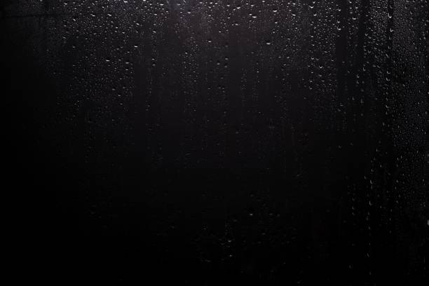 Close up for misted glass with droplets of water draining down Close up for misted glass with droplets of water draining down. black glass surface stock pictures, royalty-free photos & images