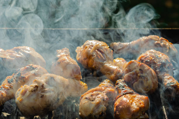 istock Cooking chicken drums on a portable metal grill. 1189209986