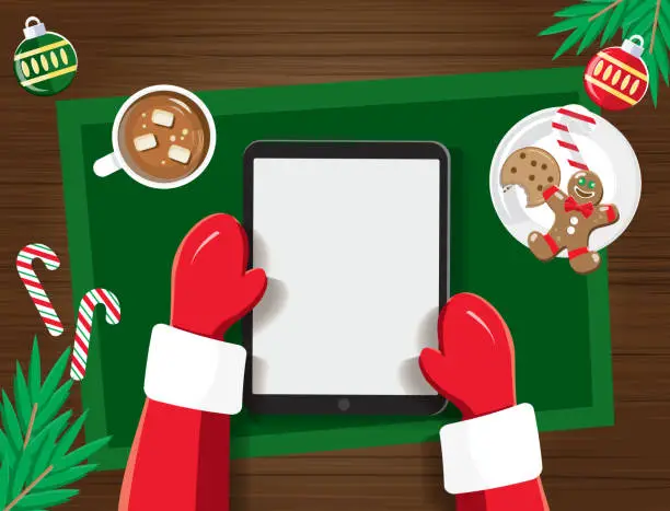 Vector illustration of Santa with blank screen on a tablet device at a desk with Christmas Elements