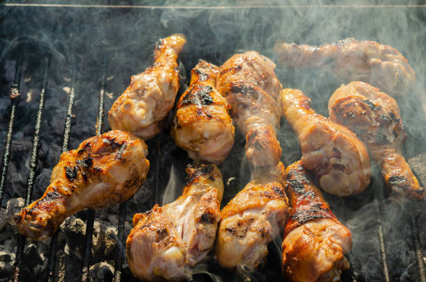 istock Cooking chicken drums on a portable metal grill. 1189209995