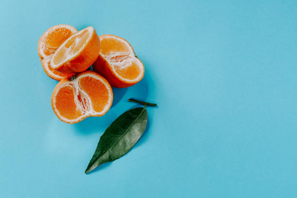 istock Fresh organic clementines on blue background 1189210030
