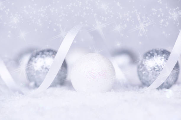 istock Christmas background. Christmas white and silver decorations on white snow 1189210039