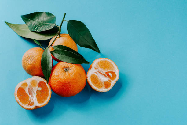 istock Fresh organic clementines on blue background 1189210044