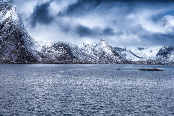 istock Amazing Snowy Mountains During Spring Time on Seashore Coastline in Norway .Horizontal Image Composition 1189210122