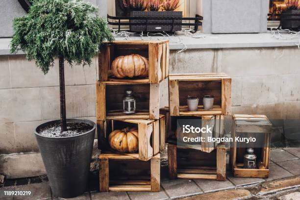 Happy Halloween Rustic Decoration With Pumpkins And Lanterns In Wooden Boxes For Halloween Celebration In European City Street Creative Arrangement Fall Holidays Stock Photo - Download Image Now