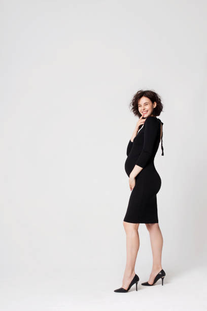 istock Beautiful pregnant woman smiling. White background, copy space. 1189211531