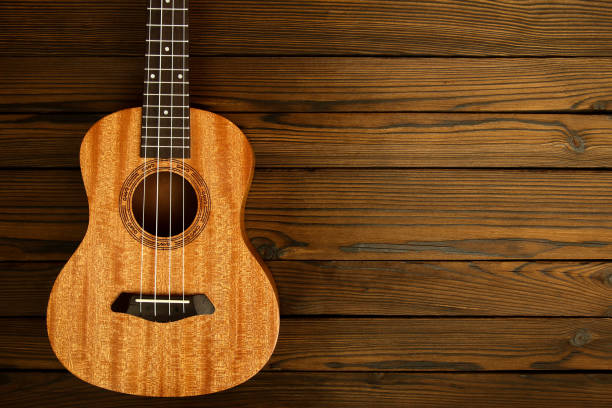 istock Ukulele musical instrument on wooden background 1189211741